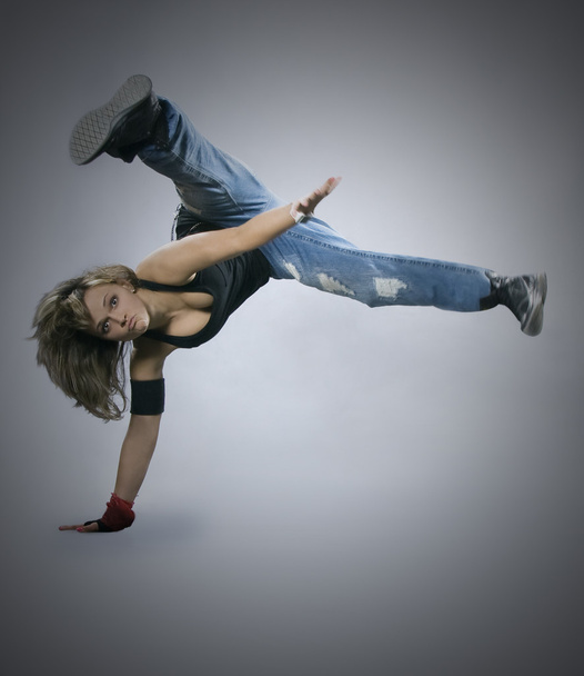 Teenage girl dancing breakdance in action - 写真・画像