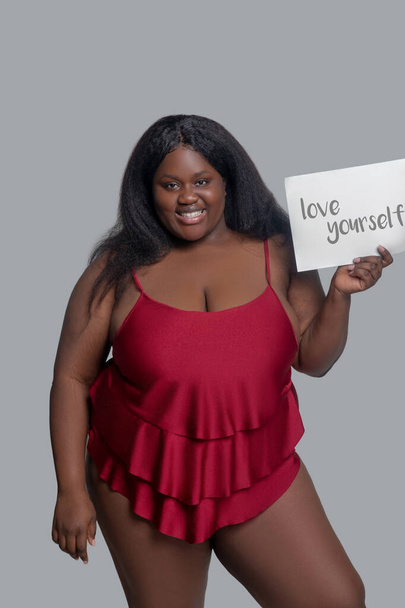 African american young woman in red underwear agitating for self love - Photo, Image
