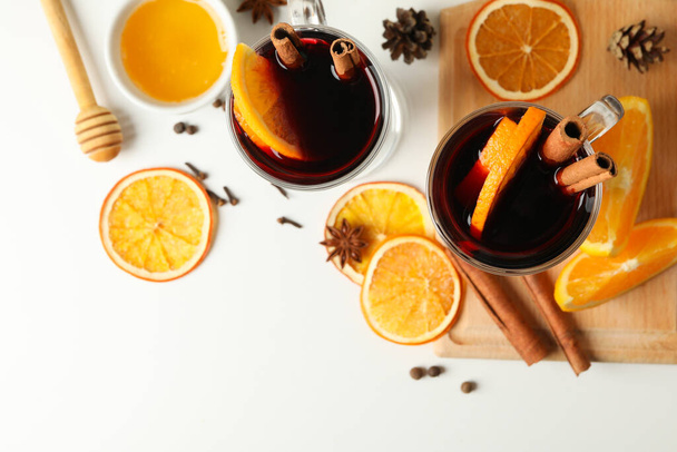 Cups of mulled wine and ingredients on white background - Photo, Image