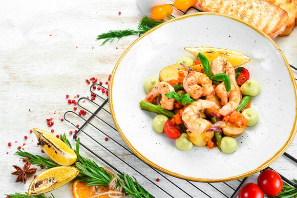 Baked shrimp with potatoes and vegetables. Top view. Free space for text. - Foto, Bild