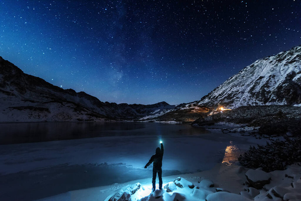 Starry sky in winter Polish Tatras near a mountain lake covered with ice - Фото, изображение