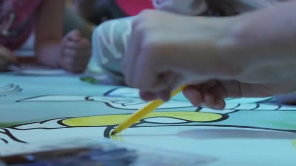 Group of Children Paint a Huge Coloring Book in Childrens Entertainment Center - Кадры, видео