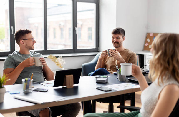 team of startuppers drinking coffee at office - Valokuva, kuva