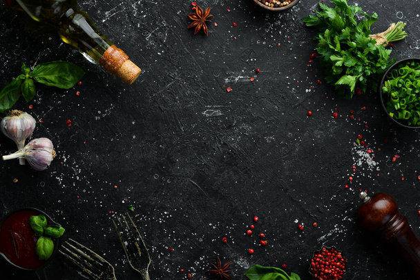 Black culinary background with spices and vegetables on the table. Top view. Free space for your text. - Photo, image