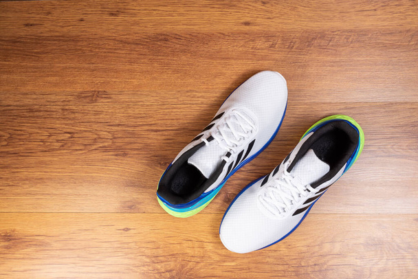 pair of running shoes on a wooden floor - Photo, Image