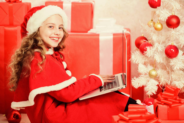 Girl little kid typing letter to santa on laptop. Child write letter to santa claus. Email and post. Modern technology. Online shopping. Letter for santa. Wish list. Child santa enjoy christmas eve - Photo, Image
