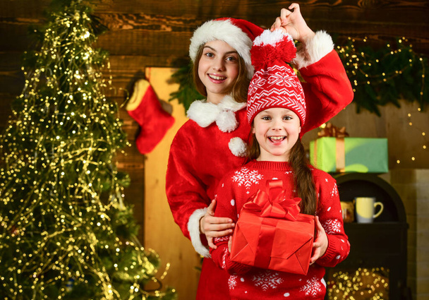 Small girls preparing holiday gift. Receiving presents. Sisterhood and family. Christmas gift for sister. Kids little cheerful girls hold gift box. Boxing day. Children picking gifts for family - Foto, imagen