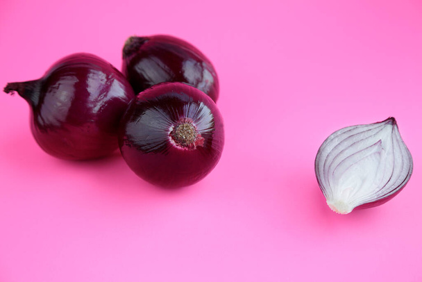 Red onions isolated on pink background - Photo, Image