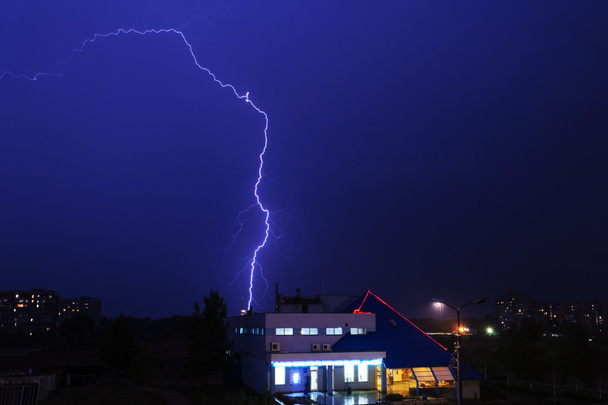 Severe lightning storm over a city buildings - Photo, Image