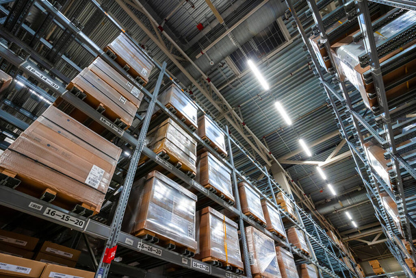Large warehouse interior with rows of shelves and carts in IKEA - Photo, Image