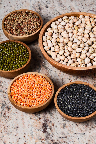 Various assortment of legumes - beans, chickpeas, lentils, black  and green orid dal. Vegetable proteins. Protein products for vegans. Healthy eating concept. Indian food. Indian style.  - Photo, Image