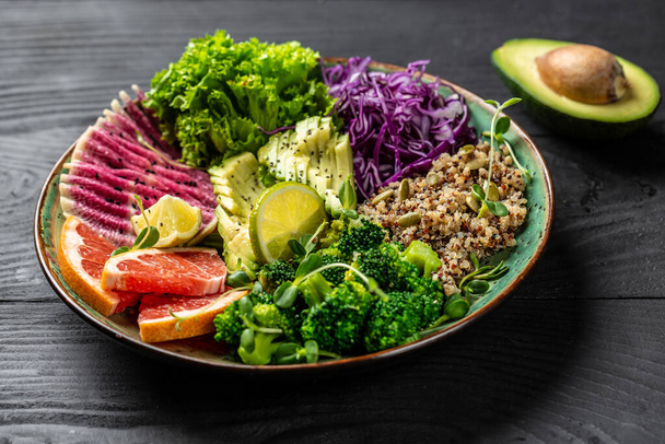 Trendy salad with quinoa, micro greens, avocado, grapefruit, broccoli, watermelon radish, red cabbage. Restaurant menu dieting, cookbook recipe. Top view flat lay, copy space. - Photo, Image