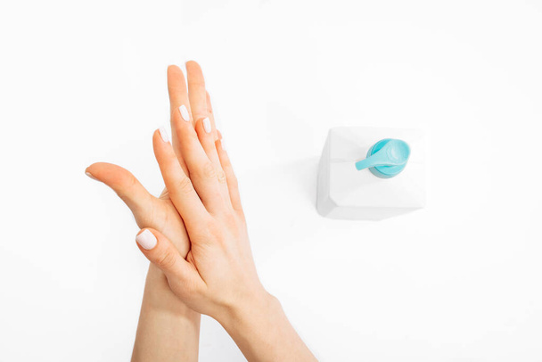 Hands applying hand sanitizer against coronavirus, on white background - Foto, Bild