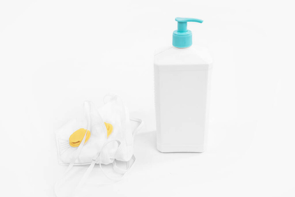 Antivirus protection kit on white background, mask, bottle of hand sanitizer, antiseptic gel, on white background - Foto, imagen