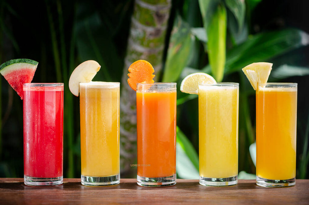 mixed fresh organic fruit juice glasses selection on sunny garden table - Photo, Image