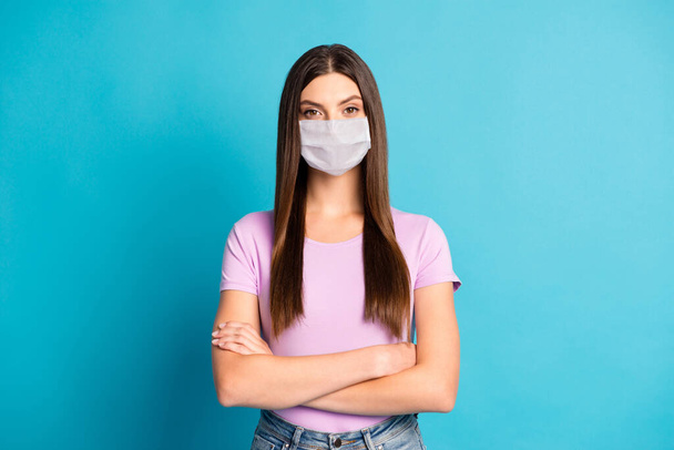 Photo of confident girl wear white face mask arms crossed isolated blue color background - Фото, зображення