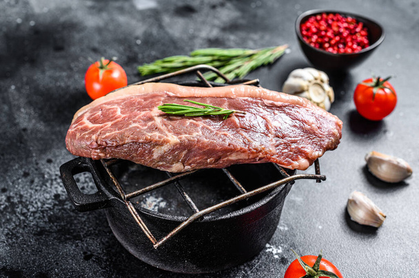 Raw rump cap steak on a grill. Black background. Top view. - Photo, Image