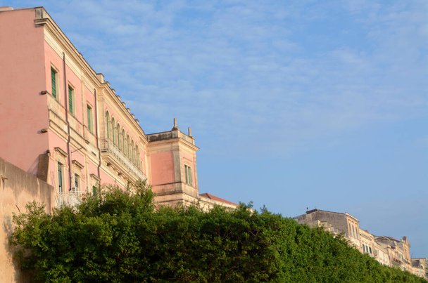 Italy - Syracuse  September 1, 2019: the elegant Art Nouveau buildings overlooking the Vittorio Emanuele II waterfront in Ortigia - Photo, Image