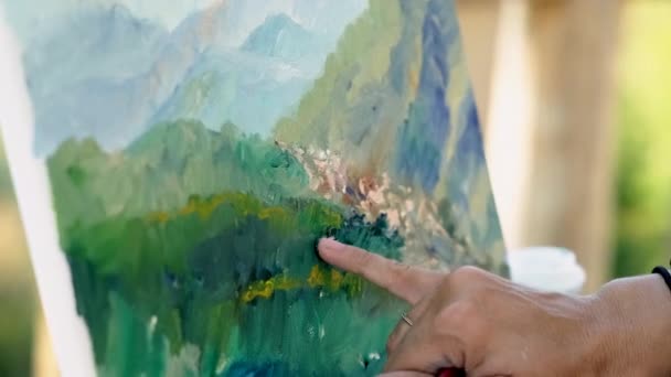 artist is drawing dye and finger on picture, closeup - Footage, Video