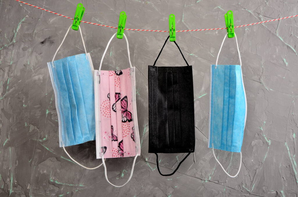 Colorful fabric face masks hanging after washing. Protection and prevention from covid19, coronavirus concept. - Foto, Bild