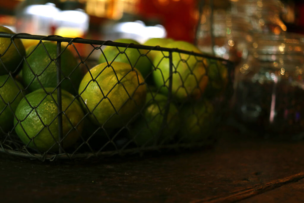 Cerca de ti una cesta de limones verdes - Foto, Imagen