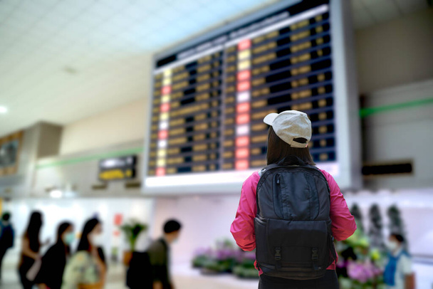 viaggiatore donna in cerca di orari dei voli presso l'aeroporto Donmuang Bangkok Thailandia - Foto, immagini