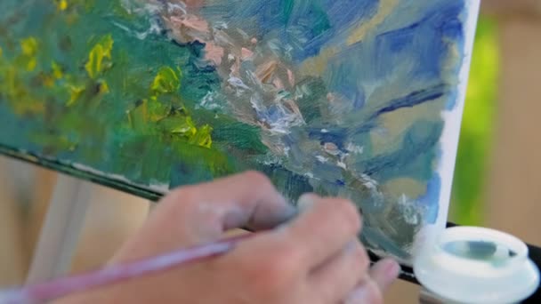 Hand of unknown painter who writing signature on picture - Footage, Video