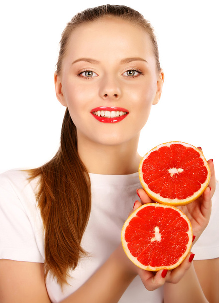 Young  woman with grapefruit in her hands studio portrait isolat - Фото, изображение