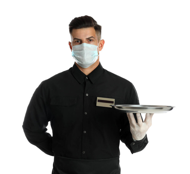 Waiter in medical face mask holding tray on white background - Photo, Image