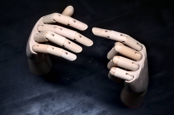 Two wooden hands that are about to touch - Fotó, kép