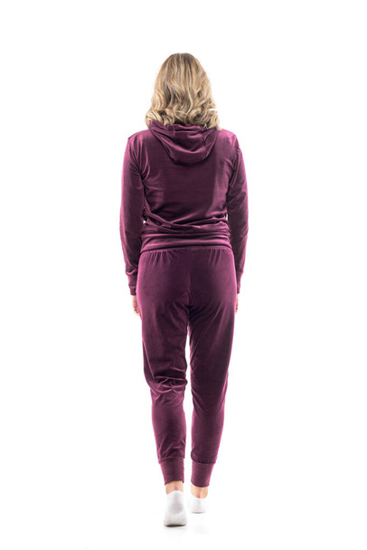 Back view of unrecognizable young woman in comfy leisurewear walking away or leaving looking ahead. Full body length isolated on white background.  - Photo, Image