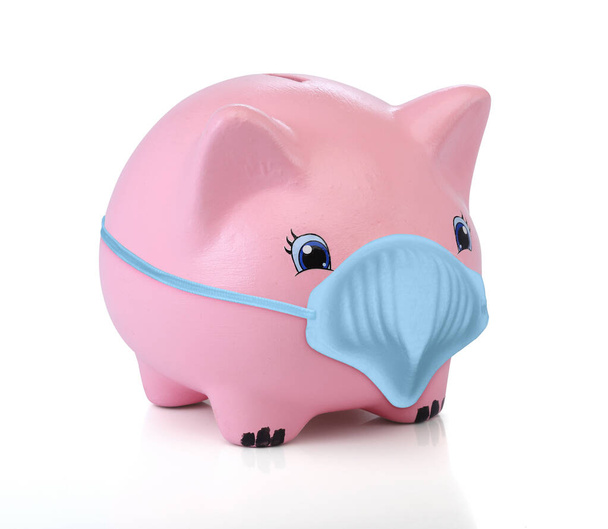 Pink piggy bank wearing a medical mask. Isolated on white background - Photo, Image