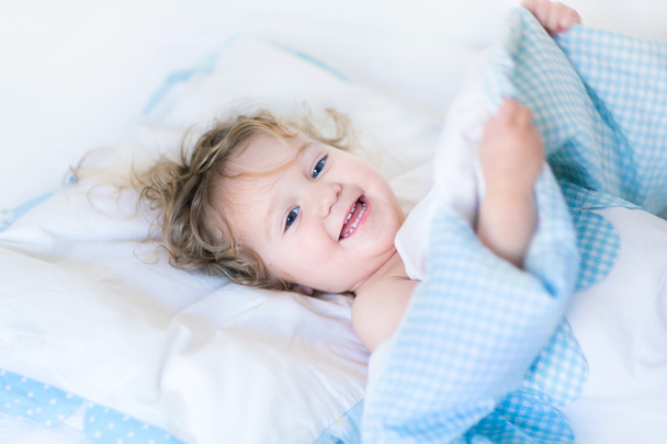 Portrait of a happy toddler waking up - Фото, изображение