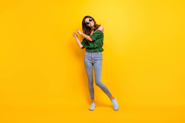 Full body photo of funky cheerful young lady dance have fun carefree isolated on vibrant yellow color background - Zdjęcie, obraz