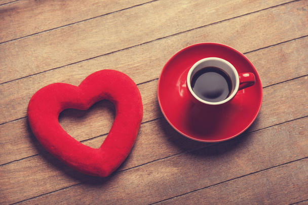 Cup of coffee and shape heart on a wooden table. - Photo, Image