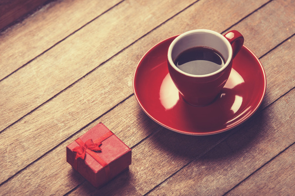 Little red gift and cup of the coffee.  - Photo, Image