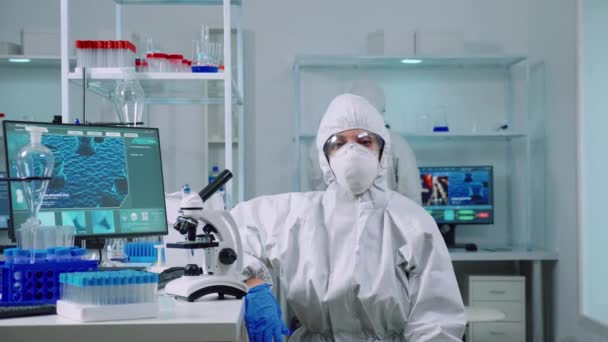 Exhausted chemist looking at camera wearing coverall - Footage, Video