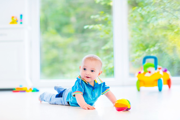 Adorable baby boy playing with a colorful ball and toy car - Photo, Image