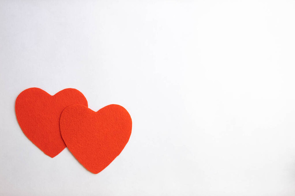 two red hearts on a white background, top view - Foto, Bild