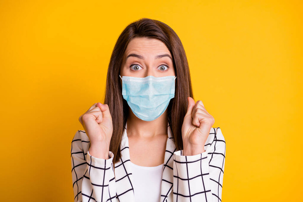 Photo of lucky businesswoman wearing blue face mask fists isolated yellow color background - Фото, зображення