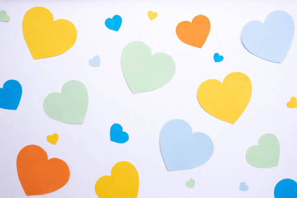 on a white background hearts made of paper of different colors, top view - 写真・画像