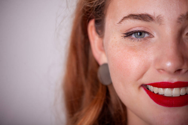 χαμόγελο χαρούμενο με κόκκινα χείλη, χαριτωμένο νεαρό κορίτσι χαμογελαστό με δόντια, χιονισμένο χαμόγελο - Φωτογραφία, εικόνα