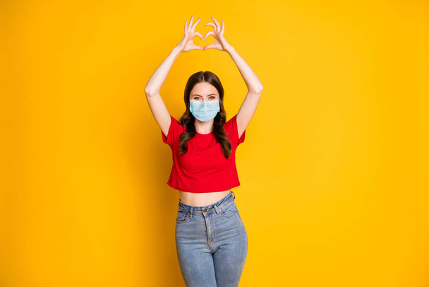 Photo of positive girl make fingers heart passionate love symbol wear mask isolated over bright shine color background - Фото, изображение