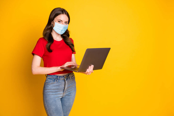 Photo of positive girl work laptop enjoy networking coworking wear mask isolated over bright shine color background - 写真・画像