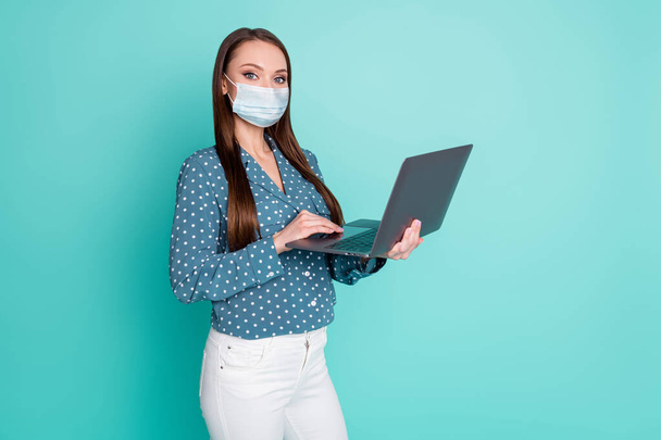 Photo of positive agent girl work laptop wear polka-dot clothes wear mask isolated over turquoise color background - 写真・画像