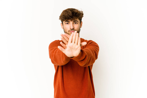 Young arab man on white background doing a denial gesture - Photo, Image