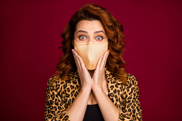 Portrait of excited lady wear medical mask good outfit isolated over dark maroon burgundy marsala color background - Photo, image