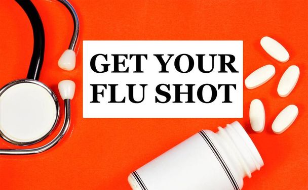 Get a flu shot. Text label in the medical folder. Stimulating the body's immune system to protect it from infectious diseases. - Photo, Image