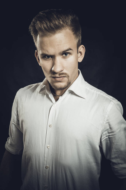 Young man dressed in white shirt studio portrait - Photo, Image