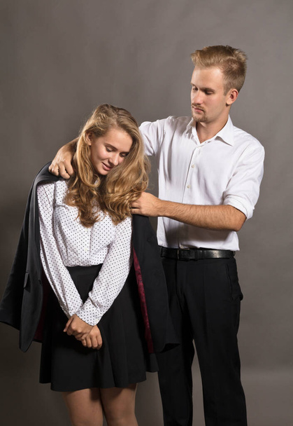 Young man giving his jacket to his girl - Foto, Imagem